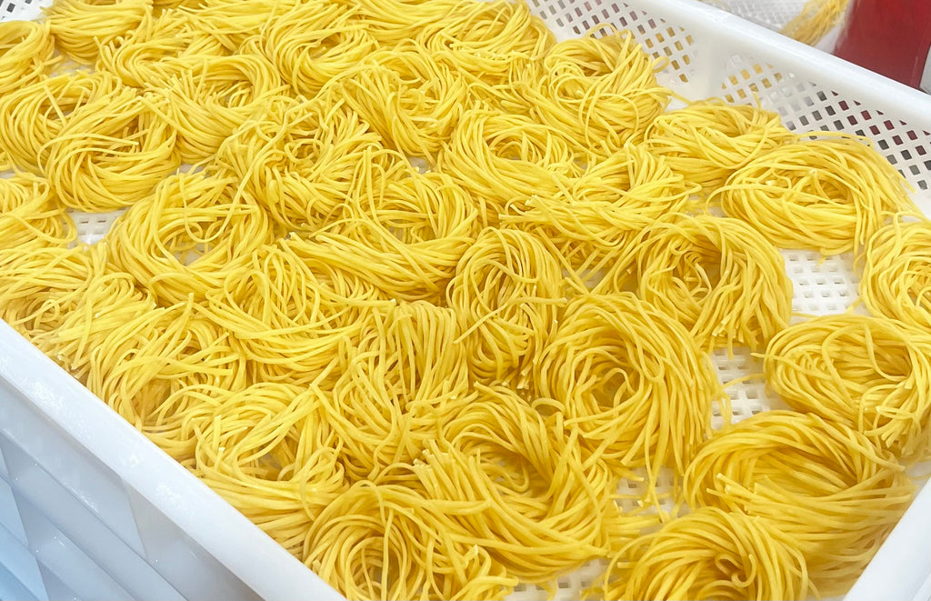 Italian semolina flour linguine noodles in a white pasta tray